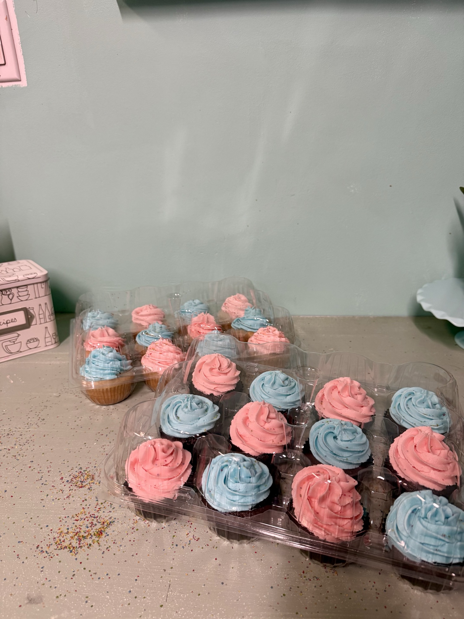 A dozen celebration cupcakes finished in pink and blue buttercream